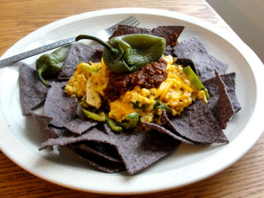 Chicken and Egg Breakfast Nachos with pasilla salsa and jalapenos.