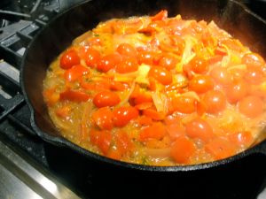 Cherry tomatoes cooking down for Tomato Coconut Curry.