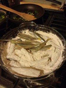 Coat the moist smelts with flour seasoned with smoked paprika, cayenne, crushed mexican oregano, salt, and pepper.