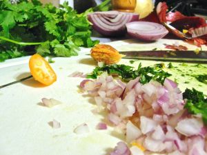 Preparing the salsa: fresh habanero, red onion, and cilantro.