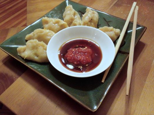 Steamed Dumplings with soy and chili garlic sauces.