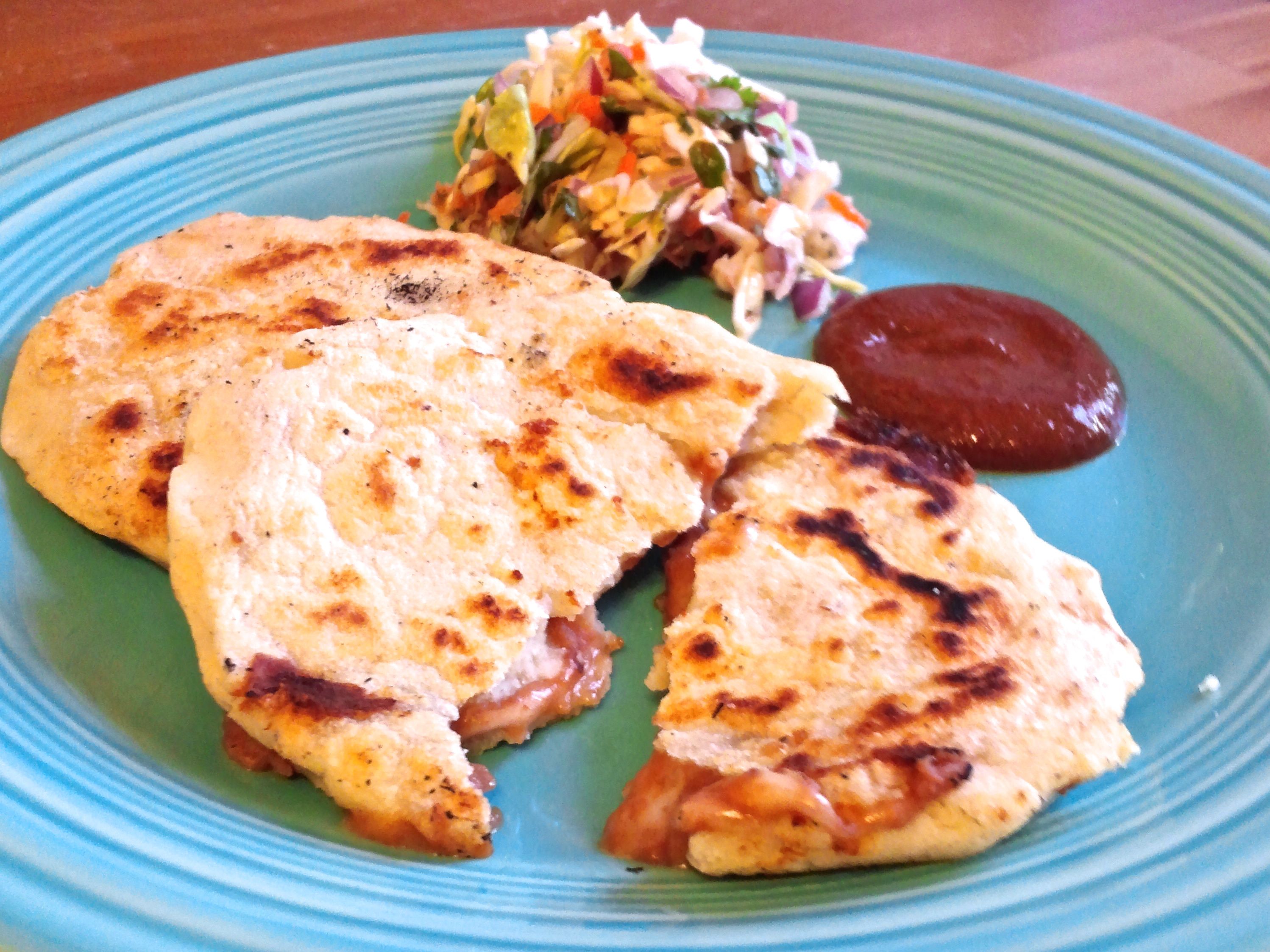 Pupusas with cabbage slaw and sauce.