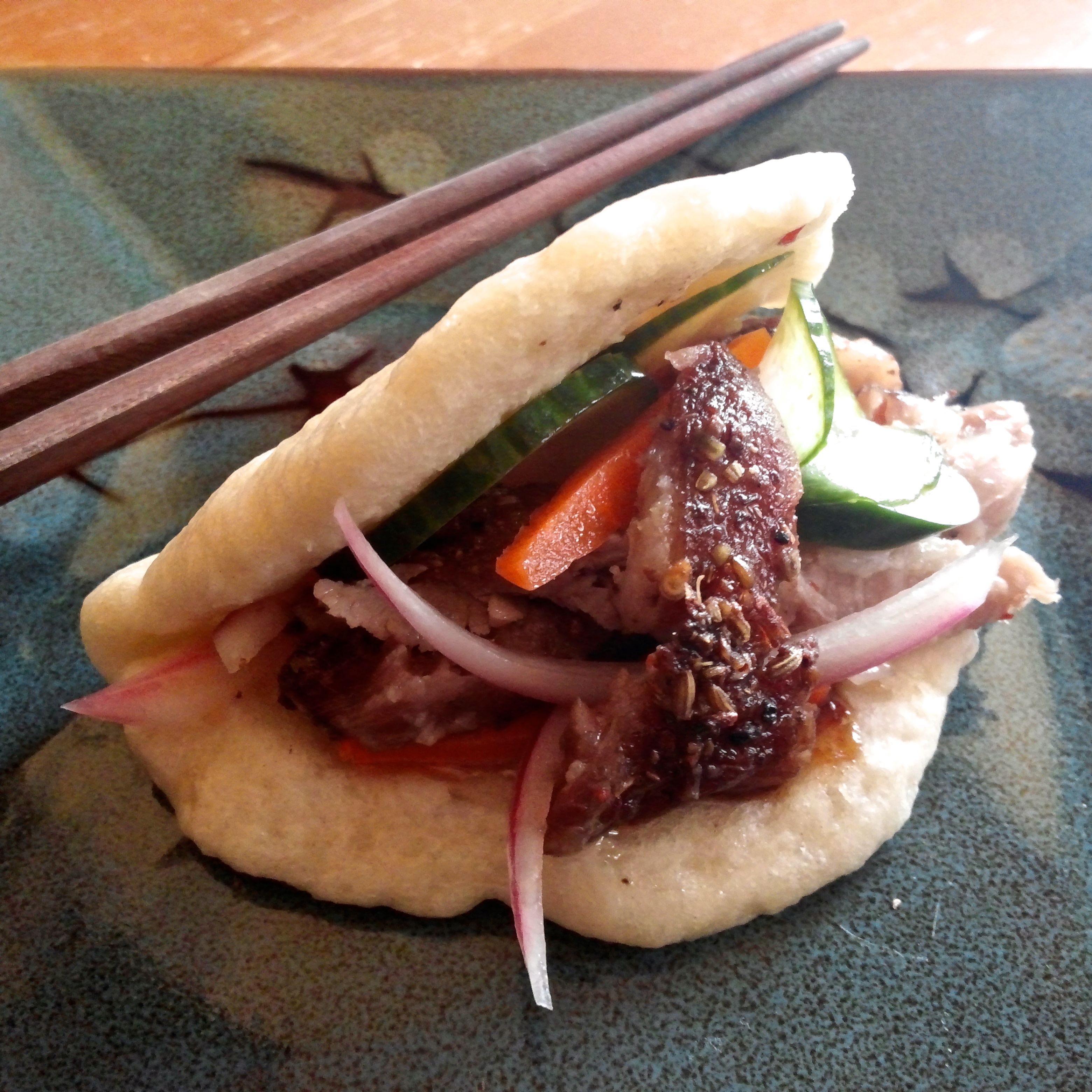 Gua bau with five spice ribs and pickled vegetables.